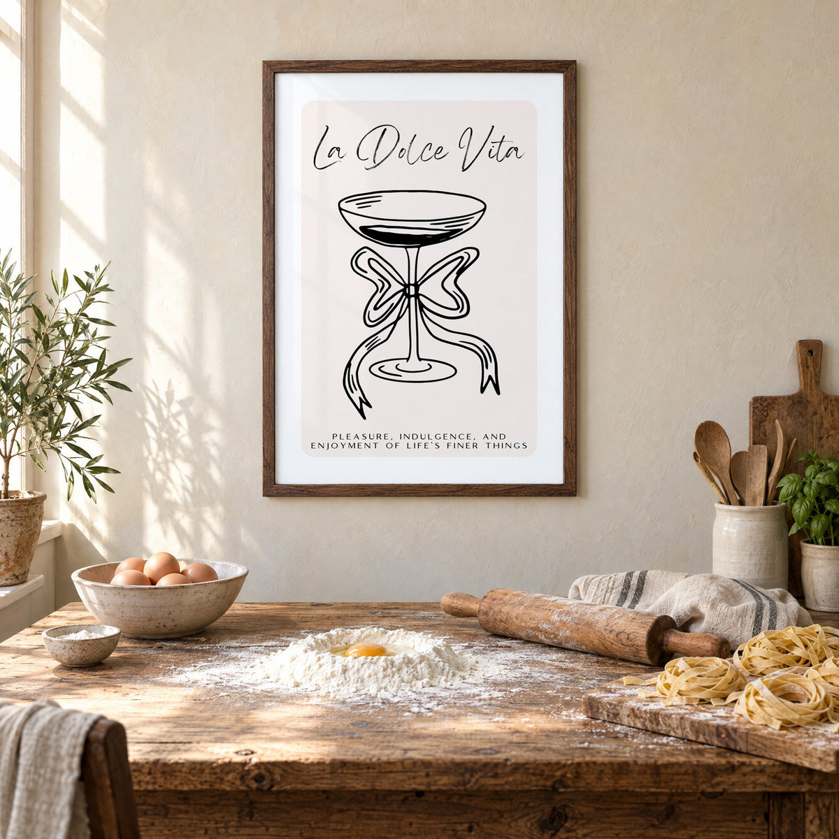 La Dolce Vita black line coupe print in a walnut frame above a rustic table set for making fresh pasta