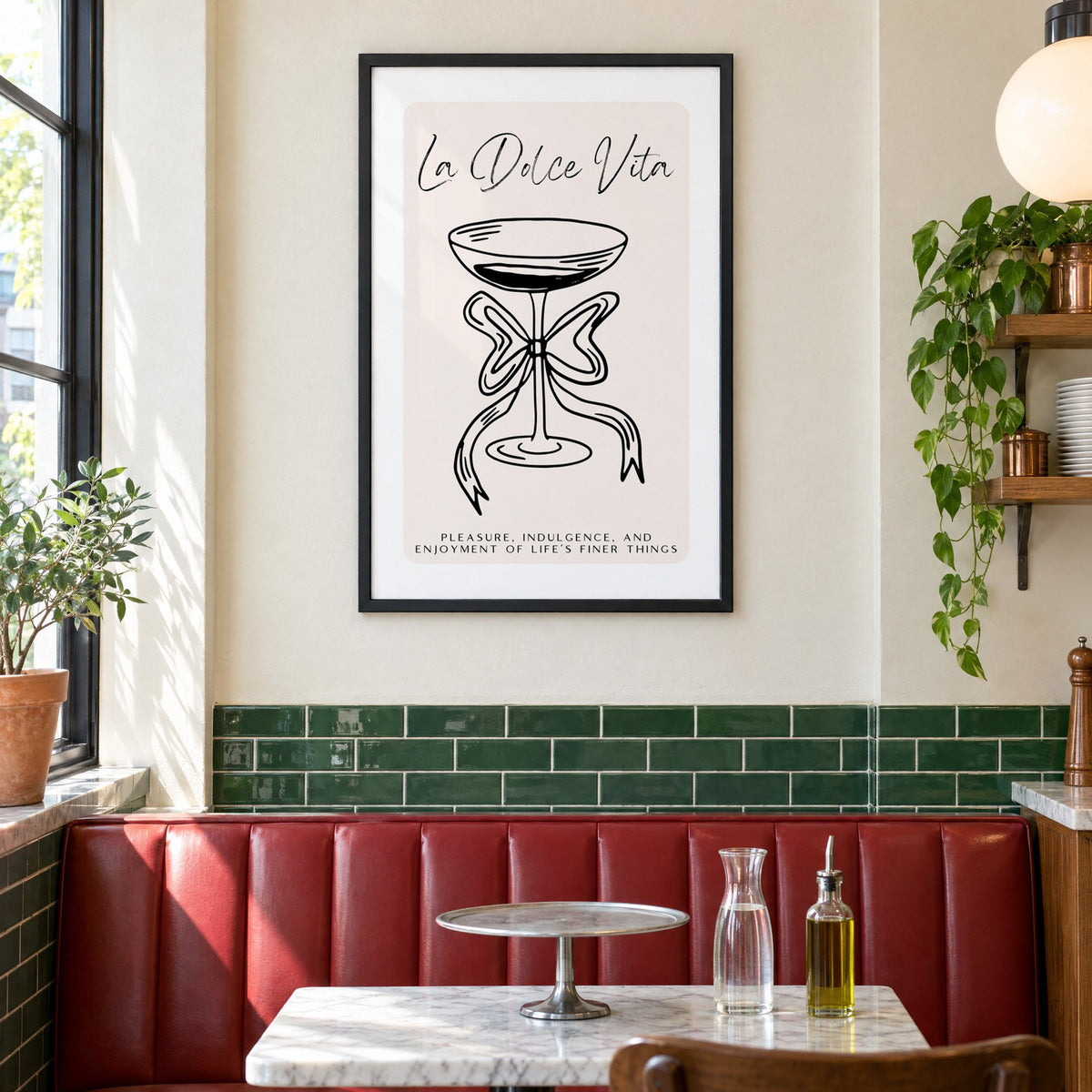 La Dolce Vita black line coupe print in a black frame above a red leather booth in a sunny pizzeria
