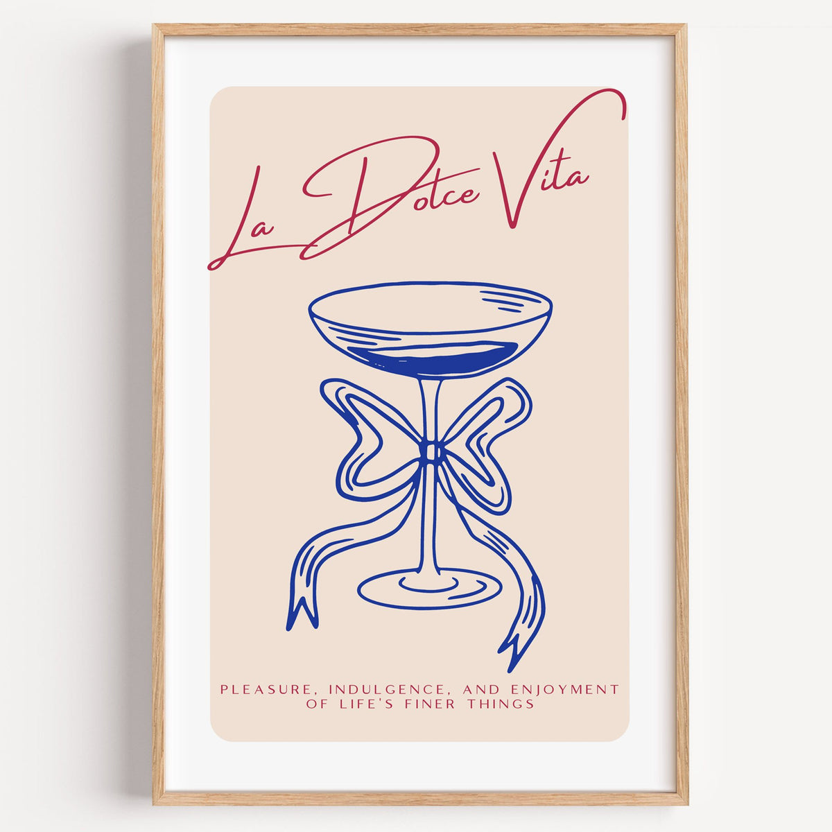 La Dolce Vita cobalt coupe print in a light oak frame on a plain white wall