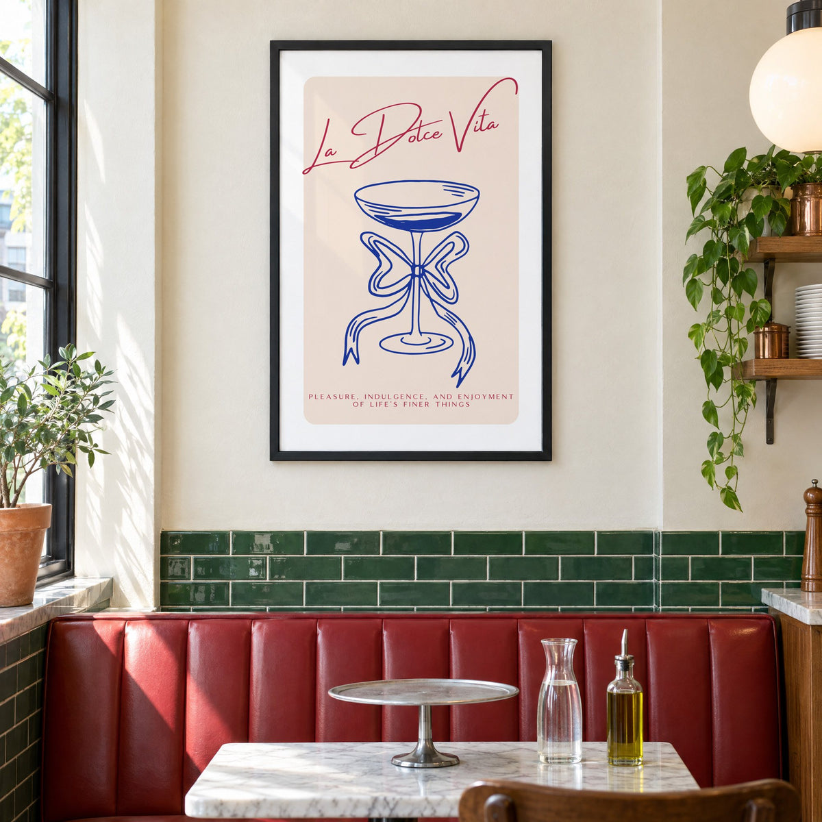 La Dolce Vita cobalt coupe print in a black frame above a red leather booth in a sunny pizzeria