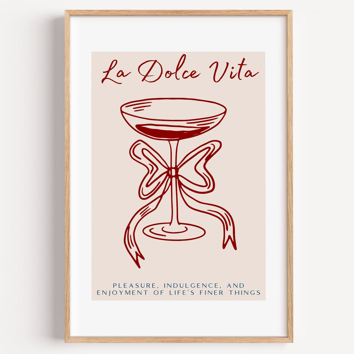 La Dolce Vita coupe bow line print in a light oak frame on a plain white wall