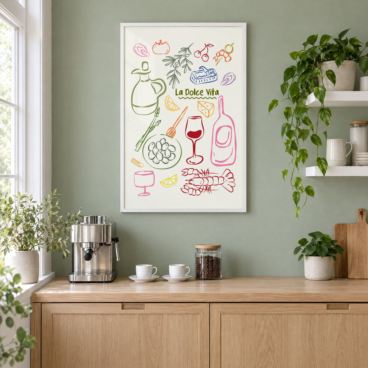 La Dolce Vita feast doodle print in a white frame on a sage green coffee nook wall above an espresso machine