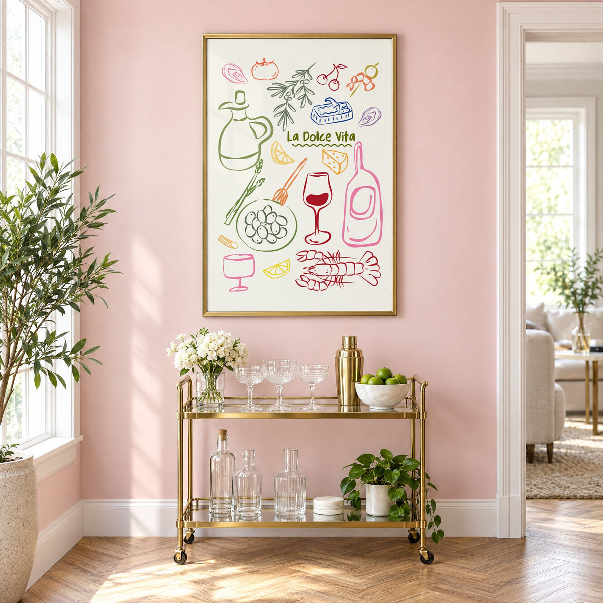 La Dolce Vita feast doodle print in a brass frame above a gold bar cart on a blush pink wall