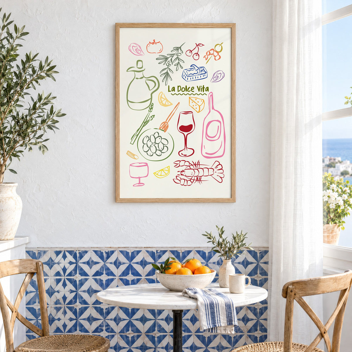 La Dolce Vita feast doodle print in an oak frame above a bistro table and blue patterned tiles