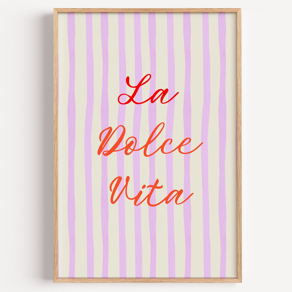 La Dolce Vita lilac stripe print in a light oak frame on a plain white wall