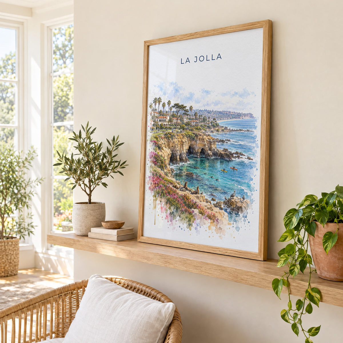 La Jolla watercolor print in an oak frame on a picture ledge in a sunlit sunroom