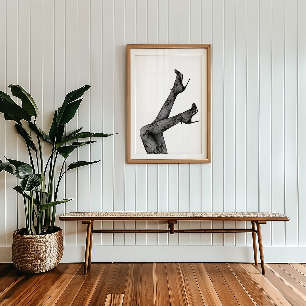 Legs in floral lace tights and stilettos print in a wood frame with a white mat above a cane bench