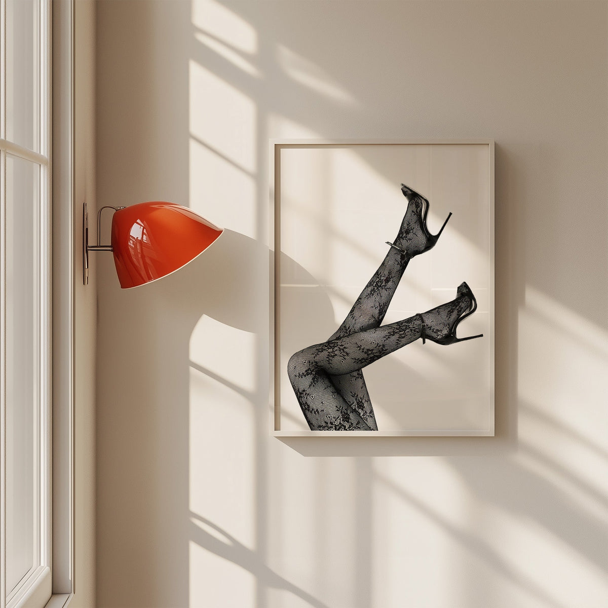 Legs in floral lace tights and stilettos print in a white frame on a sunlit wall beside a red sconce