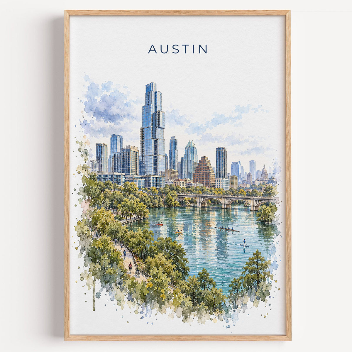 Lady Bird Lake Austin watercolor print in a light oak frame on a plain white wall