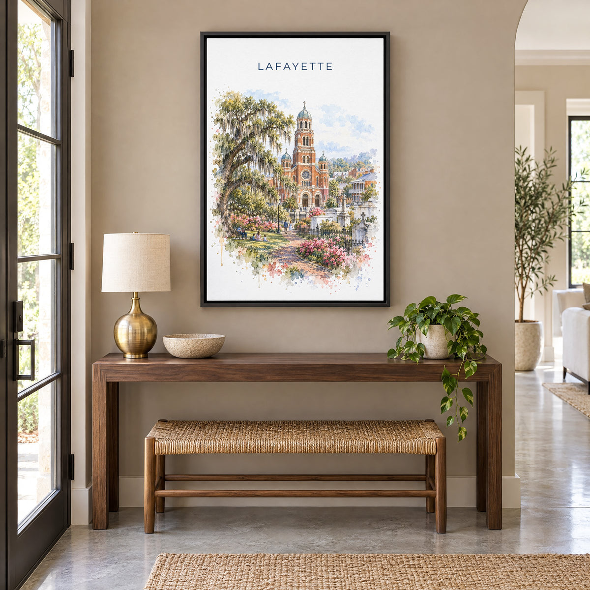 Lafayette, Louisiana watercolor print as a black floater canvas above a walnut console and woven bench in an entryway