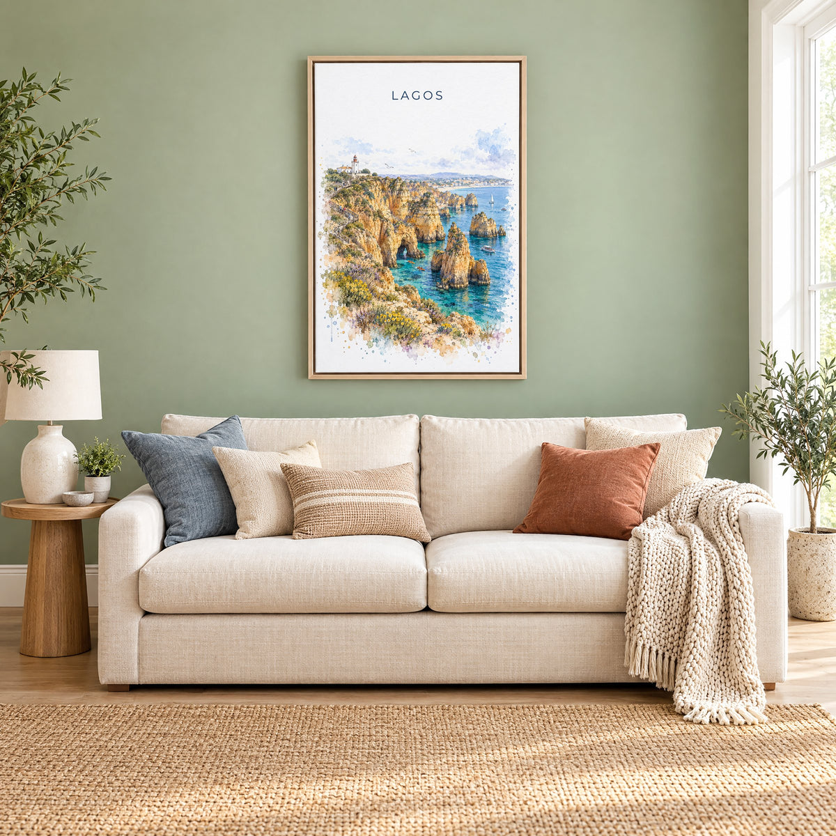 Lagos, Portugal watercolor print as a natural floater canvas above a cream linen sofa on a sage green wall