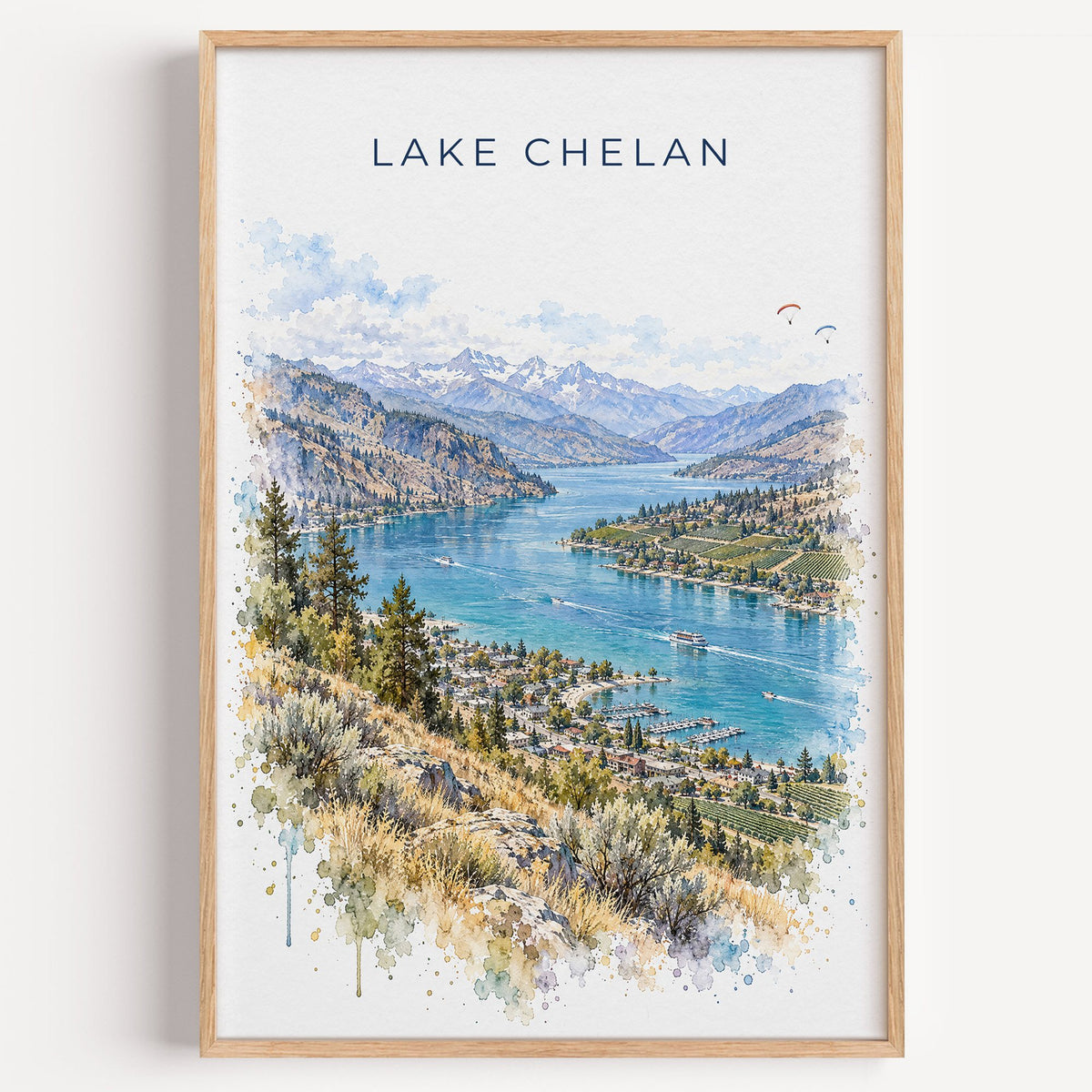 Lake Chelan watercolor print in a light oak frame on a plain white wall