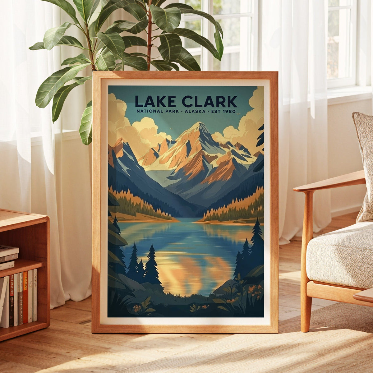 Lake Clark National Park print in an oak frame by a sunlit window with sheer curtains and a fig plant