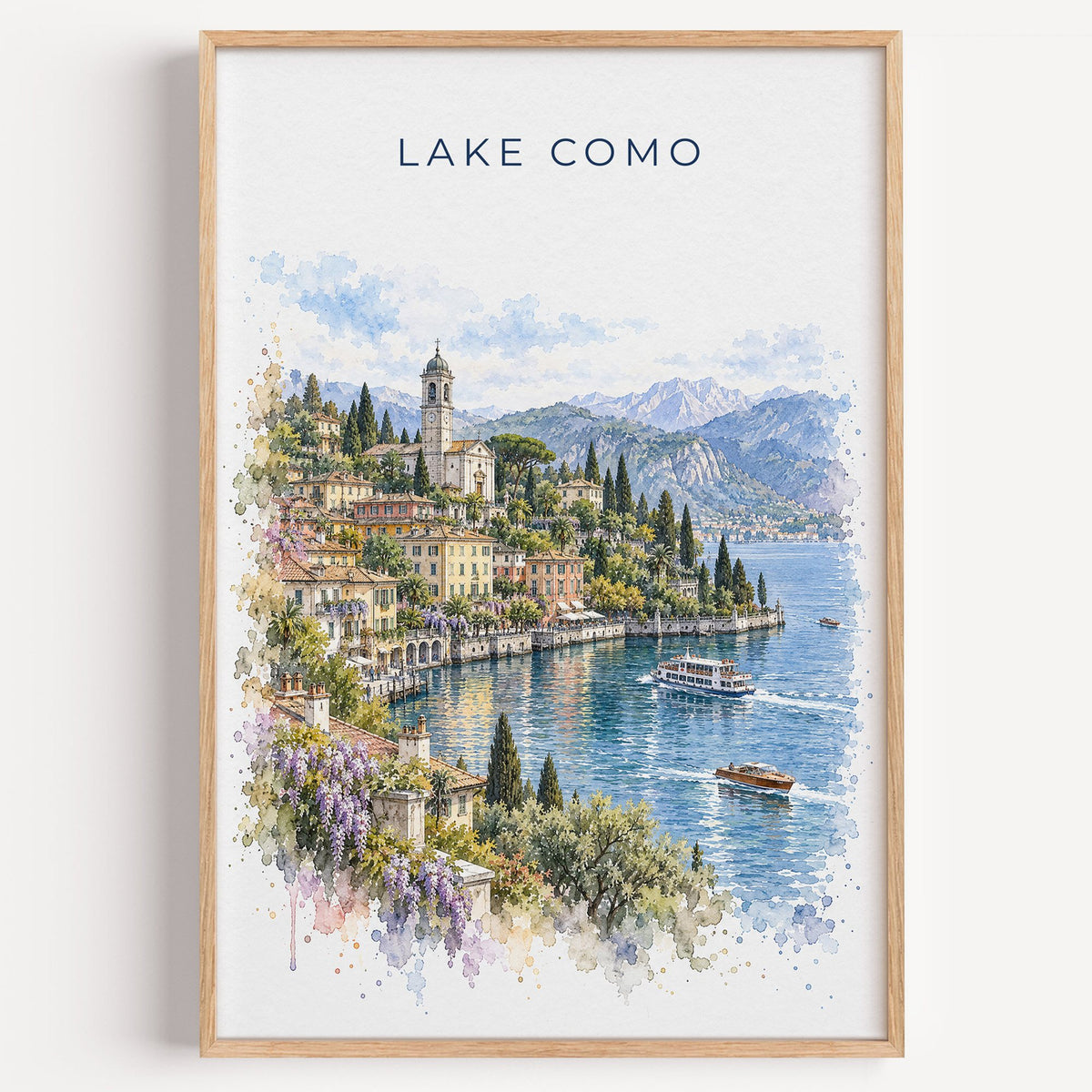 Lake Como watercolor print in a light oak frame on a plain white wall