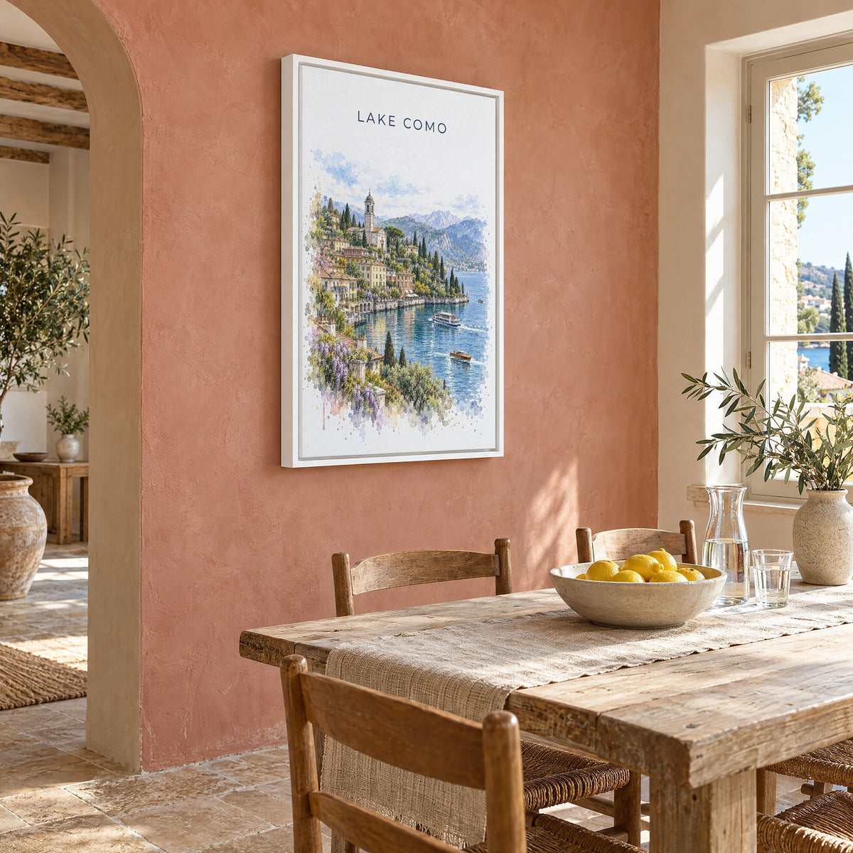 Lake Como watercolor print as a white floater canvas on a terracotta wall above a rustic dining table