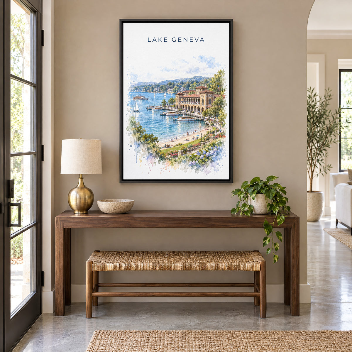 Lake Geneva, Wisconsin watercolor print as a black floater canvas above a walnut console and woven bench in an entryway
