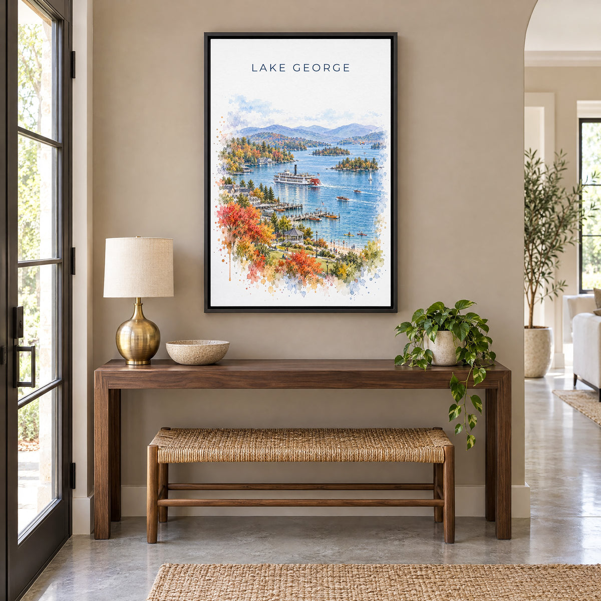 Lake George, New York watercolor print as a black floater canvas above a walnut console and woven bench in an entryway