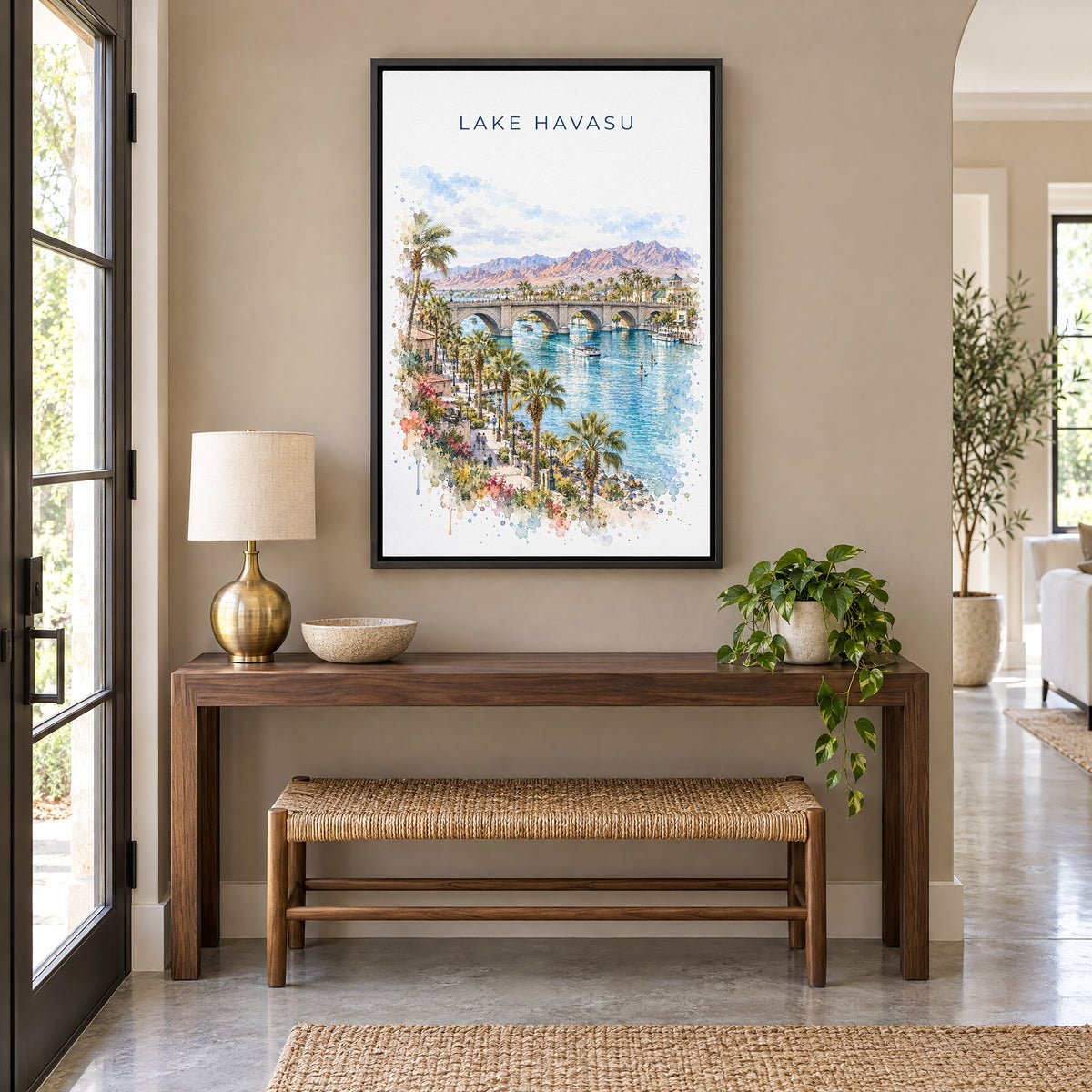 Lake Havasu watercolor print as a black floater canvas above a walnut console and woven bench in an entryway