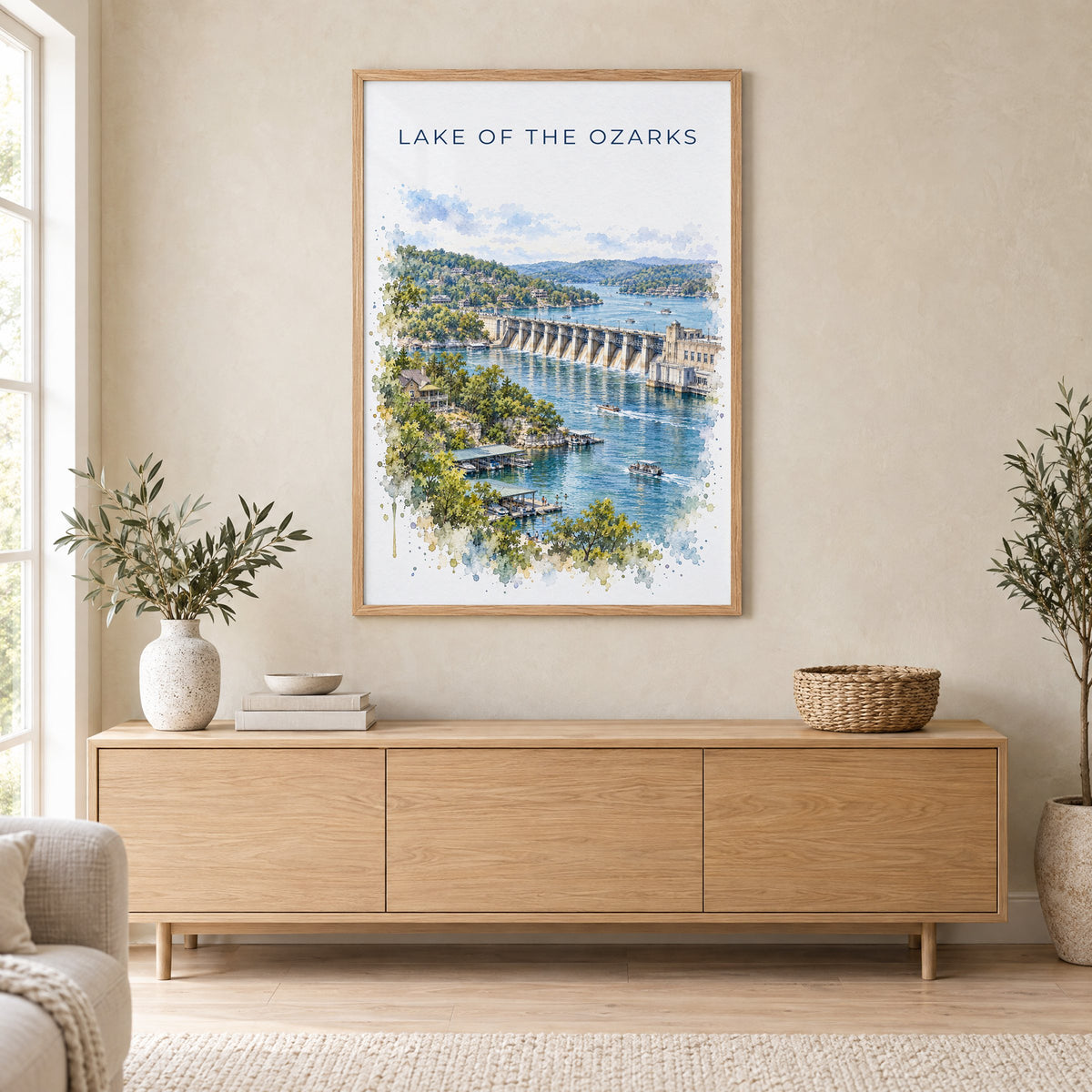 Lake of the Ozarks watercolor print in an oak frame above a light wood sideboard in a Scandinavian living room