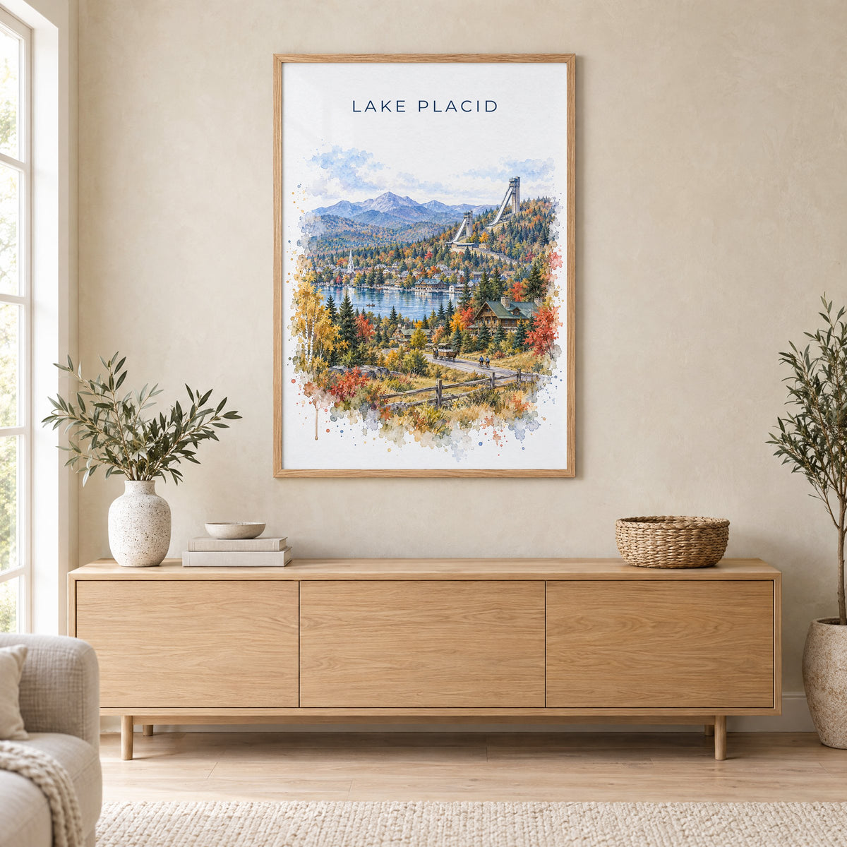 Lake Placid watercolor print in an oak frame above a light wood sideboard in a Scandinavian living room