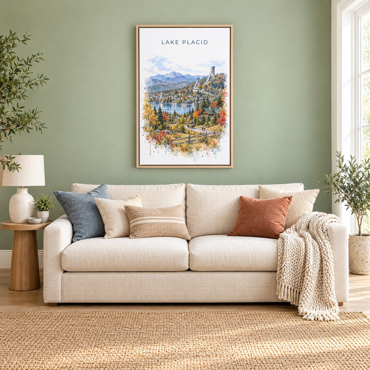 Lake Placid watercolor print as a natural floater canvas above a cream linen sofa on a sage green wall