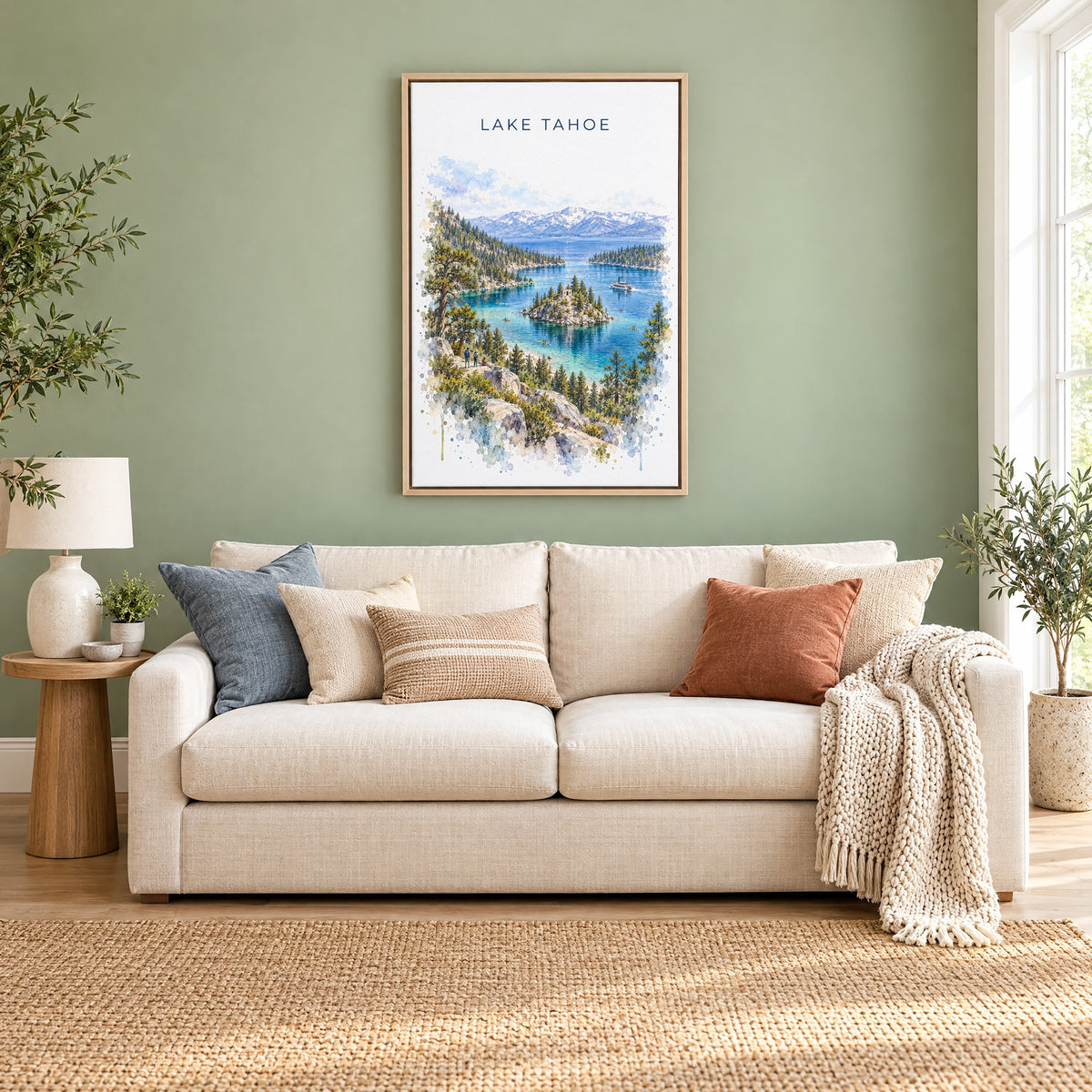 Lake Tahoe watercolor print as a natural floater canvas above a cream linen sofa on a sage green wall