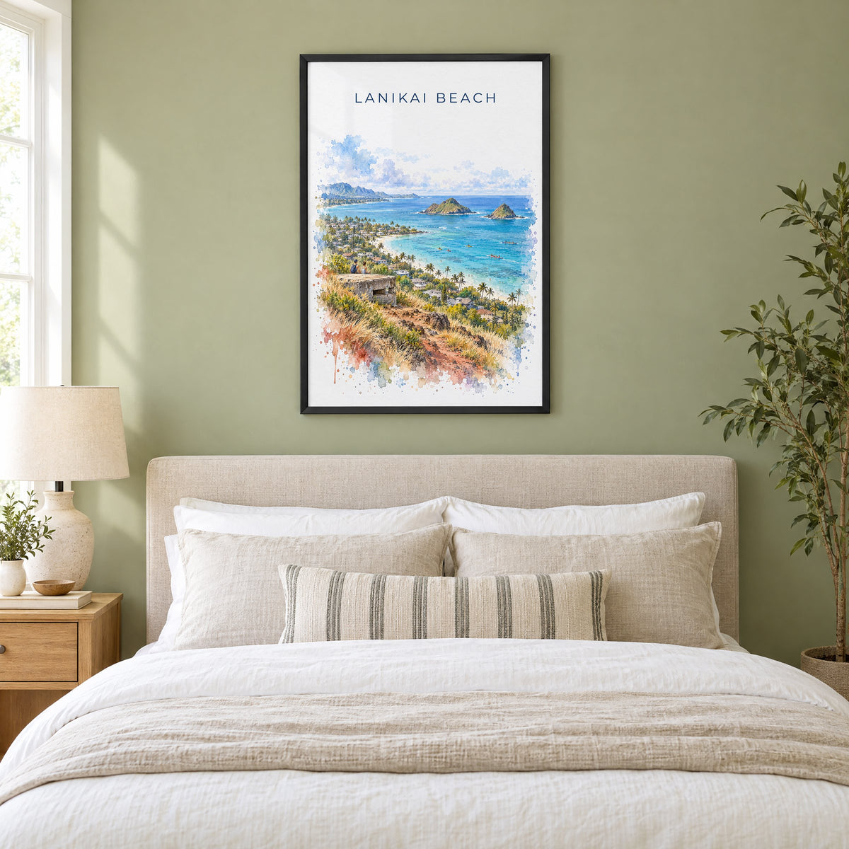 Lanikai Beach watercolor print in a black frame above an upholstered headboard in a sage green bedroom