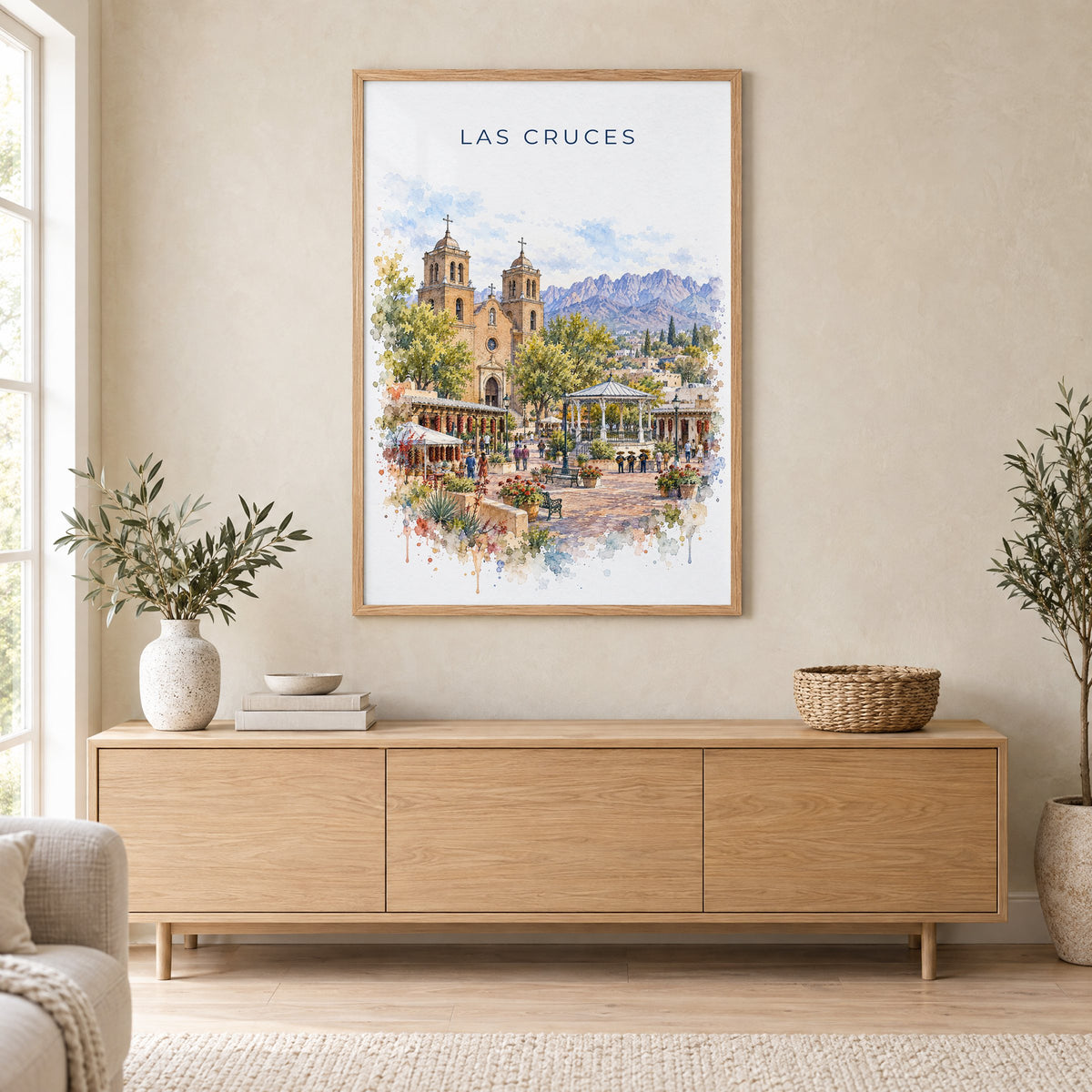 Las Cruces watercolor print in an oak frame above a light wood sideboard in a Scandinavian living room