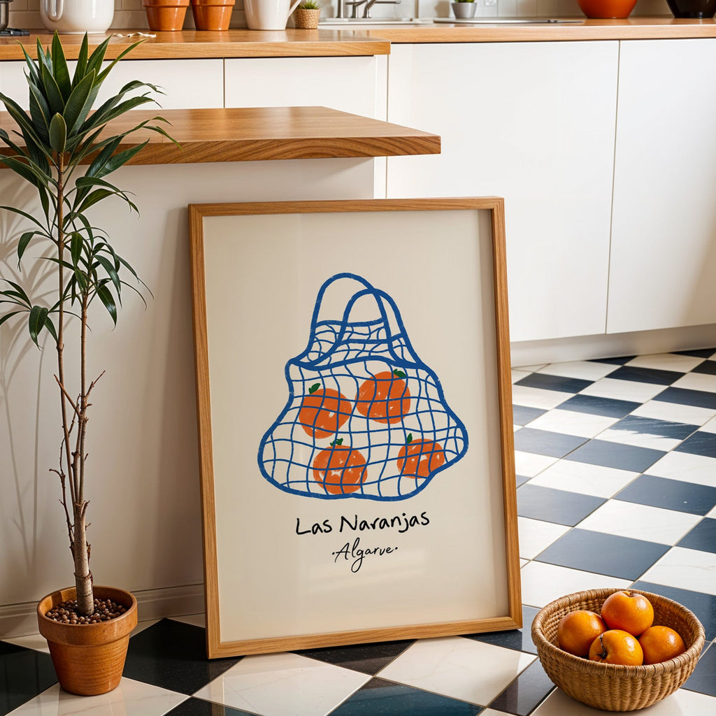 Las naranjas orange net bag print in an oak frame by a kitchen island and checkered floor