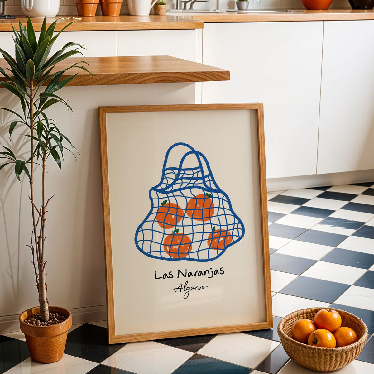 Las naranjas orange net bag print in an oak frame by a kitchen island and checkered floor