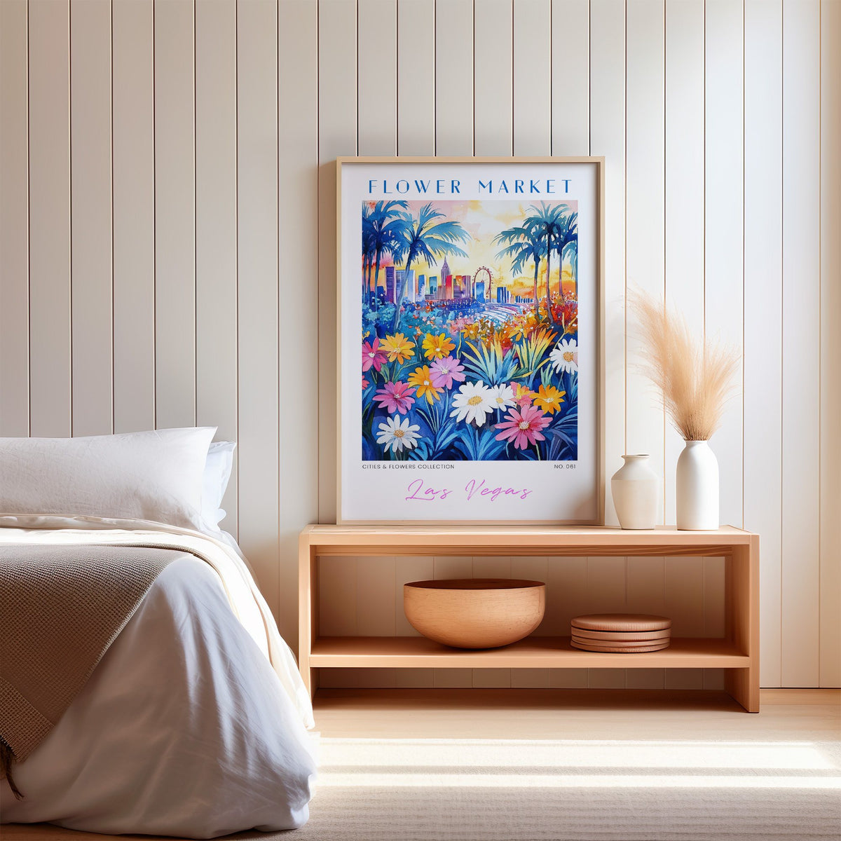 Las Vegas flower market print in an oak frame on a wood bench against a white shiplap bedroom wall with pampas grass