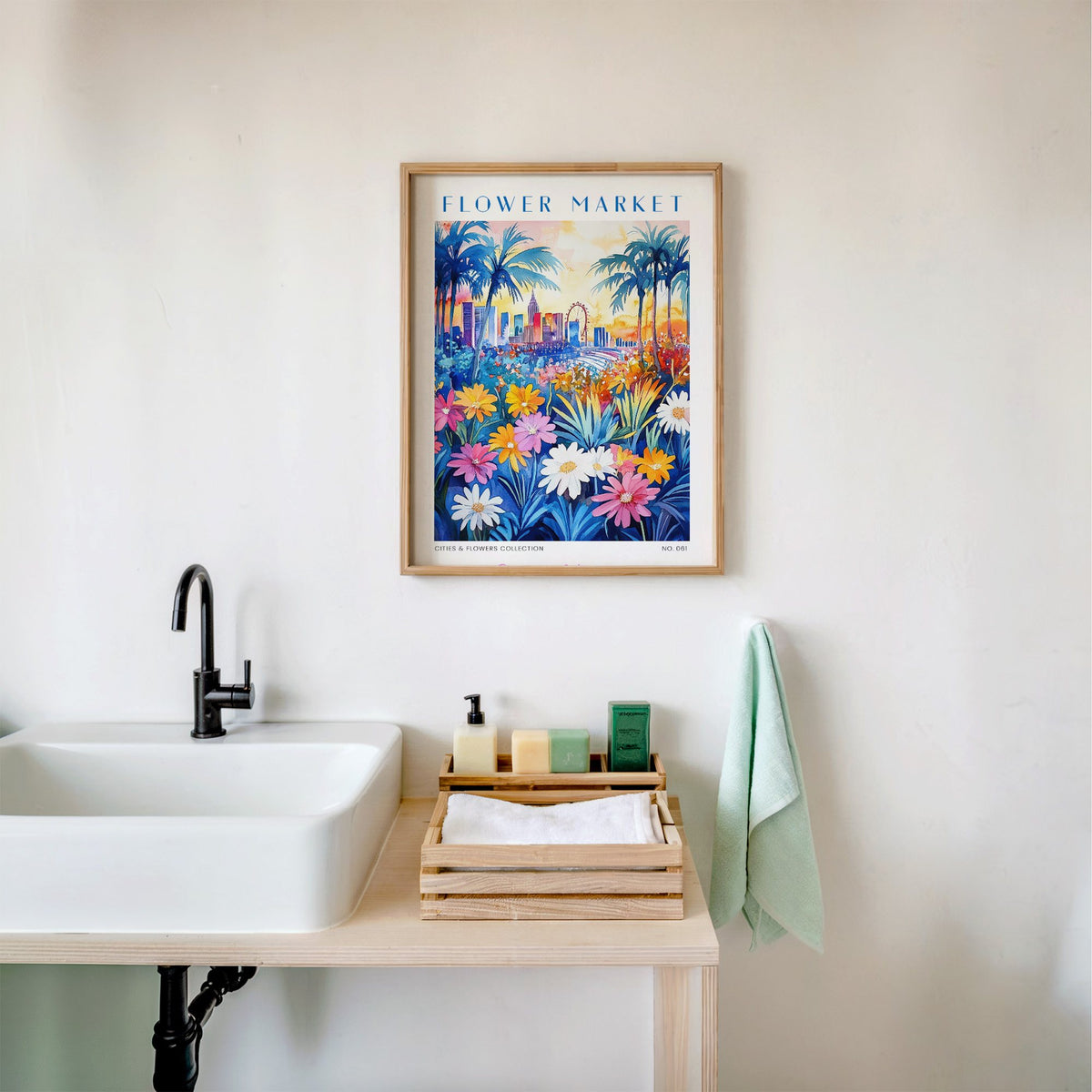 Las Vegas flower market print in an oak frame above a white bathroom sink with folded towels