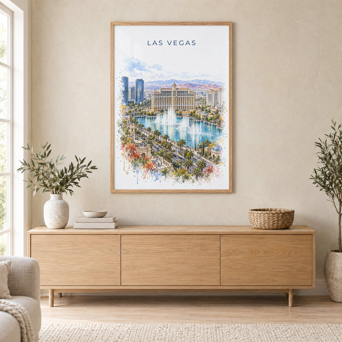 Las Vegas watercolor print in an oak frame above a light wood sideboard in a Scandinavian living room
