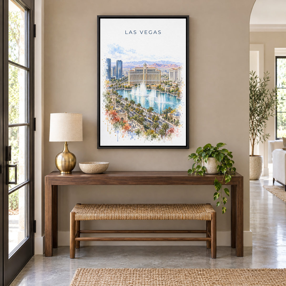 Las Vegas watercolor print as a black floater canvas above a walnut console and woven bench in an entryway
