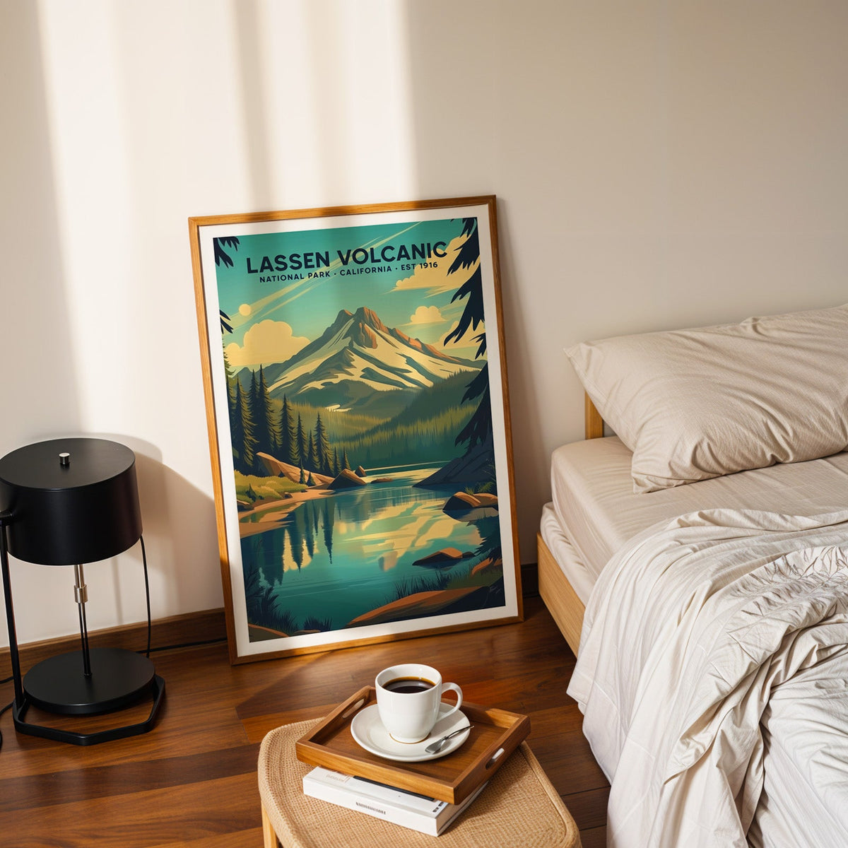 Lassen Volcanic National Park print in an oak frame leaning on a bedroom floor beside the bed and a coffee tray