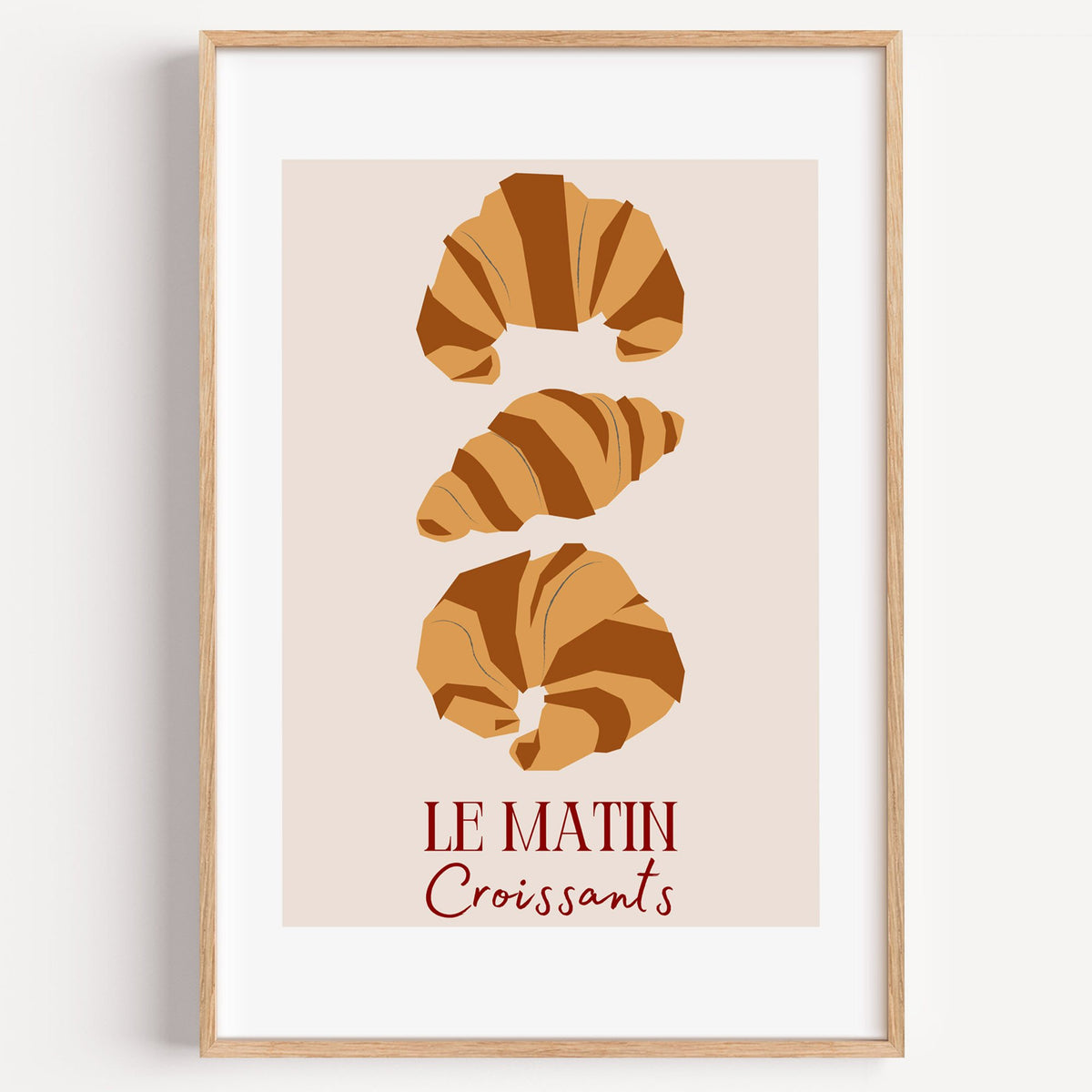 LE MATIN Croissants caramel trio print in a light oak frame on a plain white wall