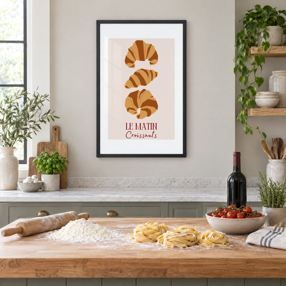 LE MATIN Croissants caramel trio print in a black frame above a butcher-block island with fresh pasta, flour and cherry tomatoes