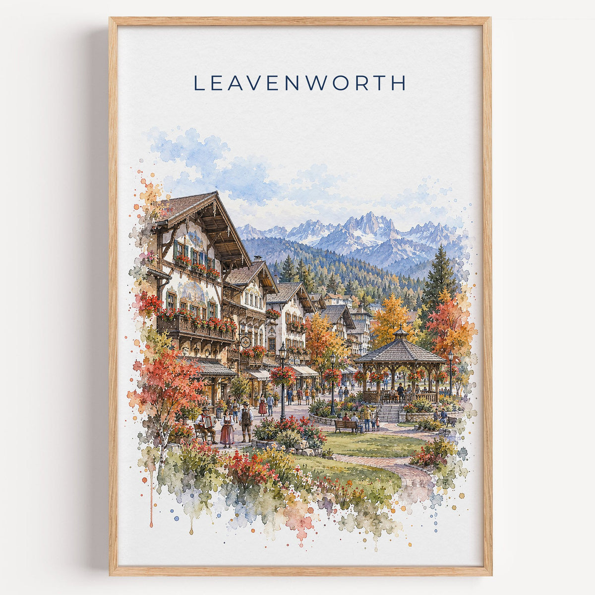 Leavenworth watercolor print in a light oak frame on a plain white wall