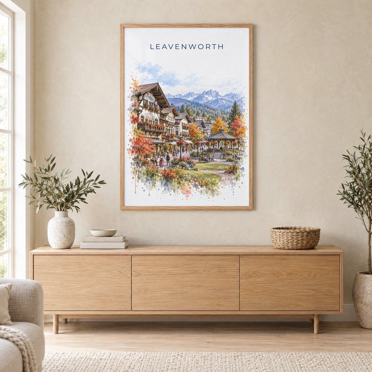 Leavenworth watercolor print in an oak frame above a light wood sideboard in a Scandinavian living room