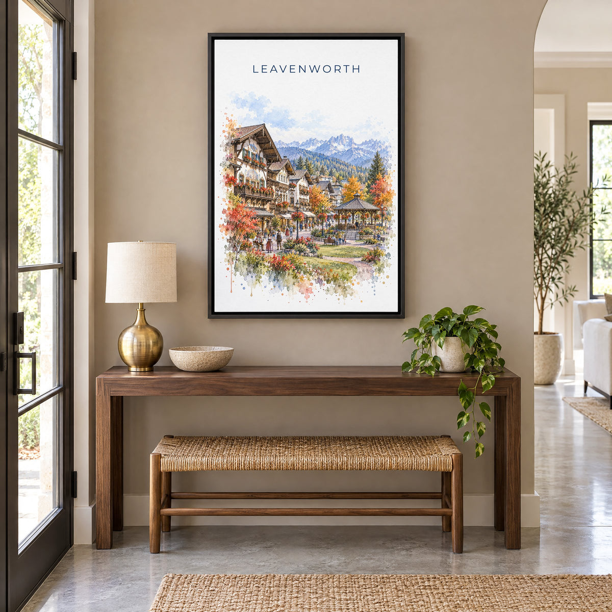 Leavenworth watercolor print as a black floater canvas above a walnut console and woven bench in an entryway