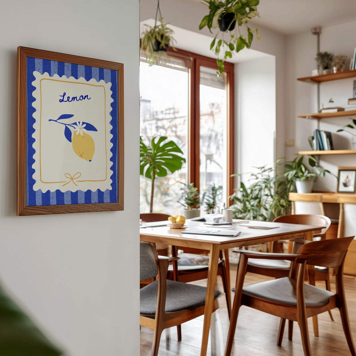 Lemon branch print in a walnut frame beside a mid-century dining table
