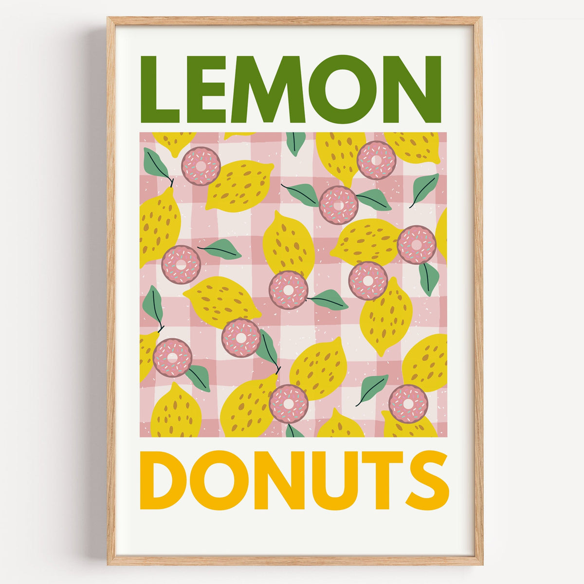 Lemon and donuts gingham print in a light oak frame on a plain white wall