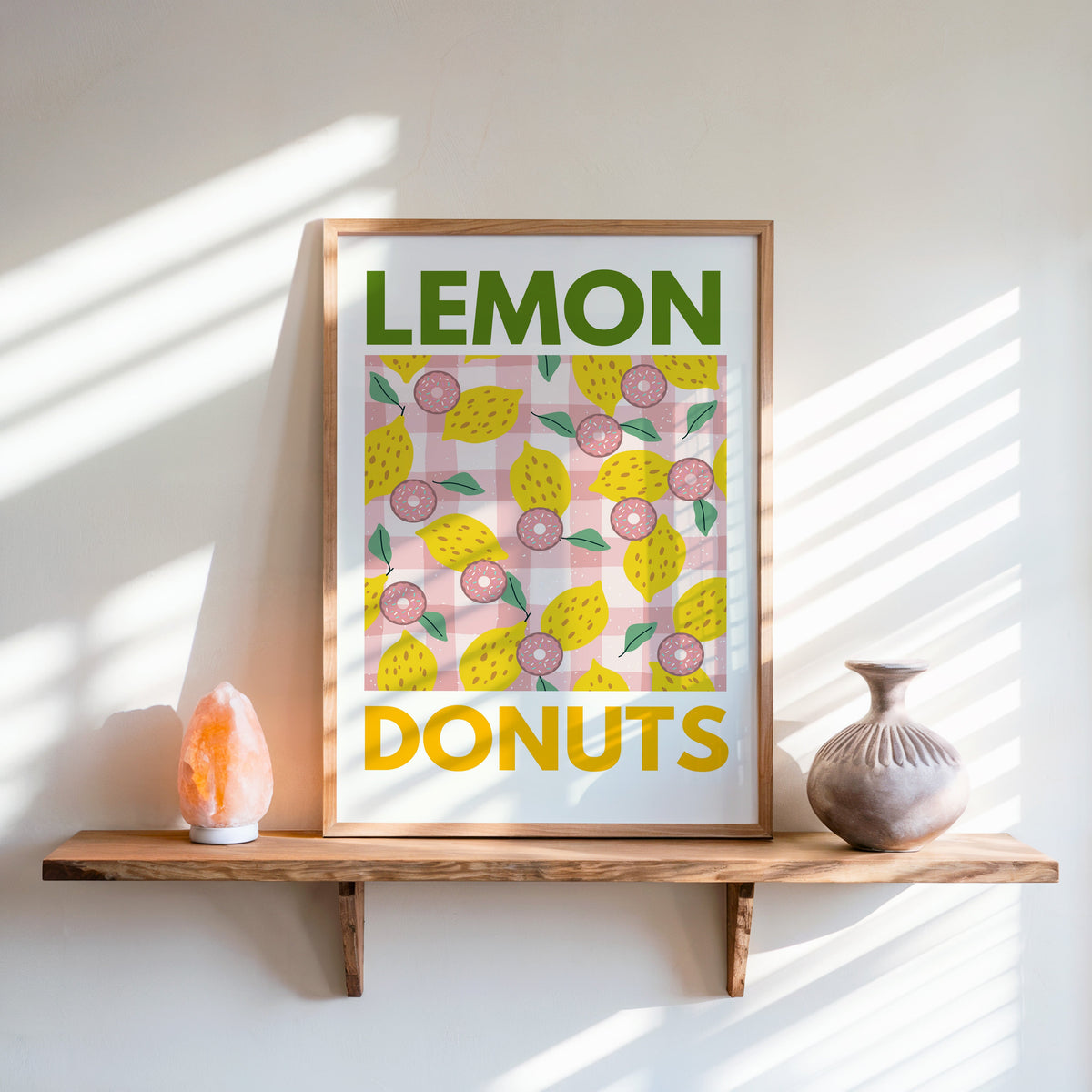Lemon and donuts print in an oak frame on a live-edge shelf beside a salt lamp