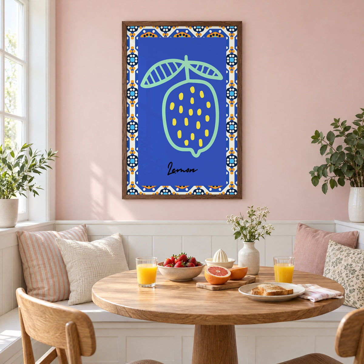 Lemon mint outline cobalt tile print in a walnut frame on a pastel pink wall above a breakfast nook with strawberries and orange juice
