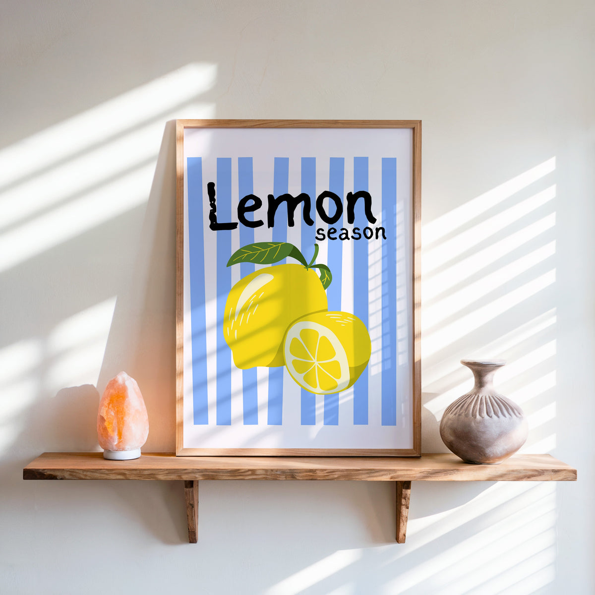 Lemon Season print in an oak frame on a live-edge shelf beside a salt lamp