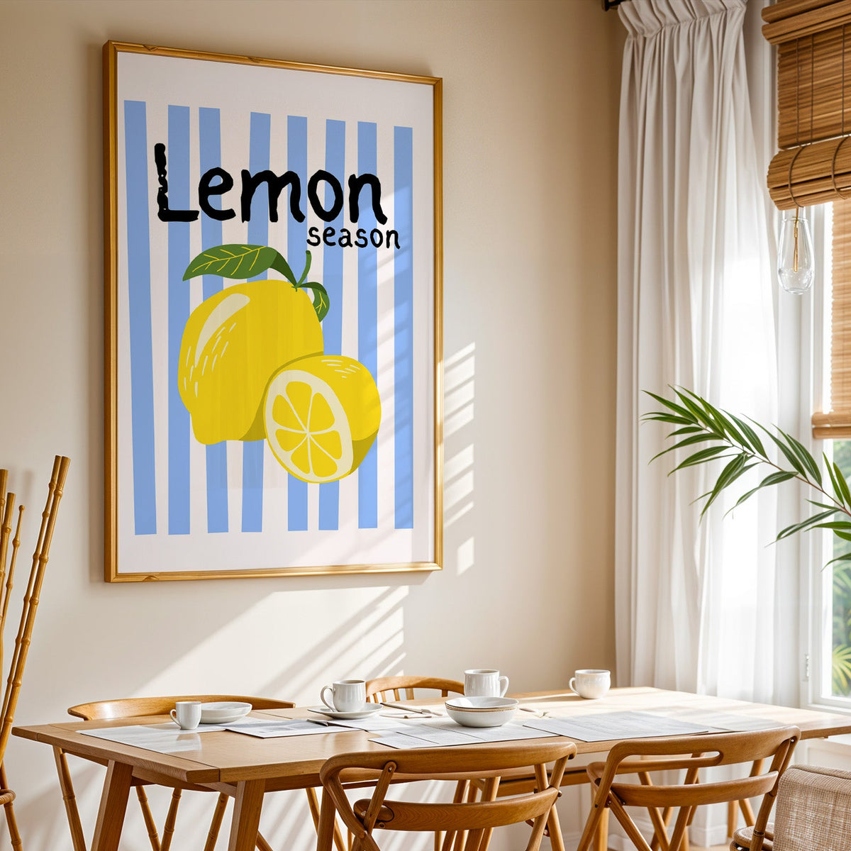Lemon Season print shown in a gold frame above a breakfast table by a curtained window
