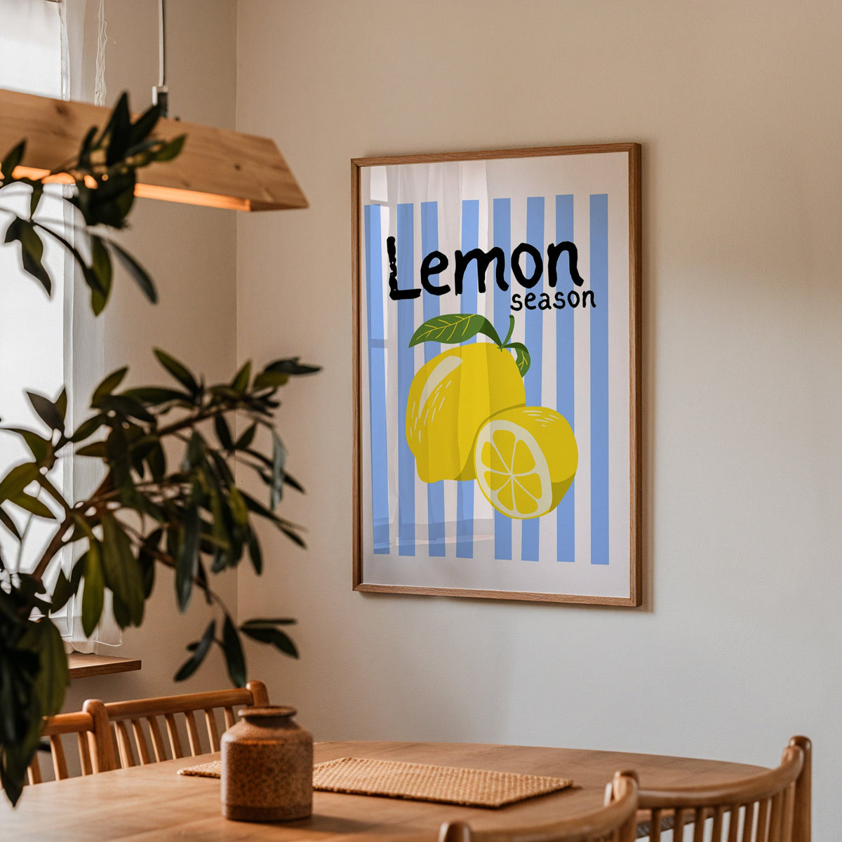 Lemon Season print in a walnut frame above a dining table with olive branches
