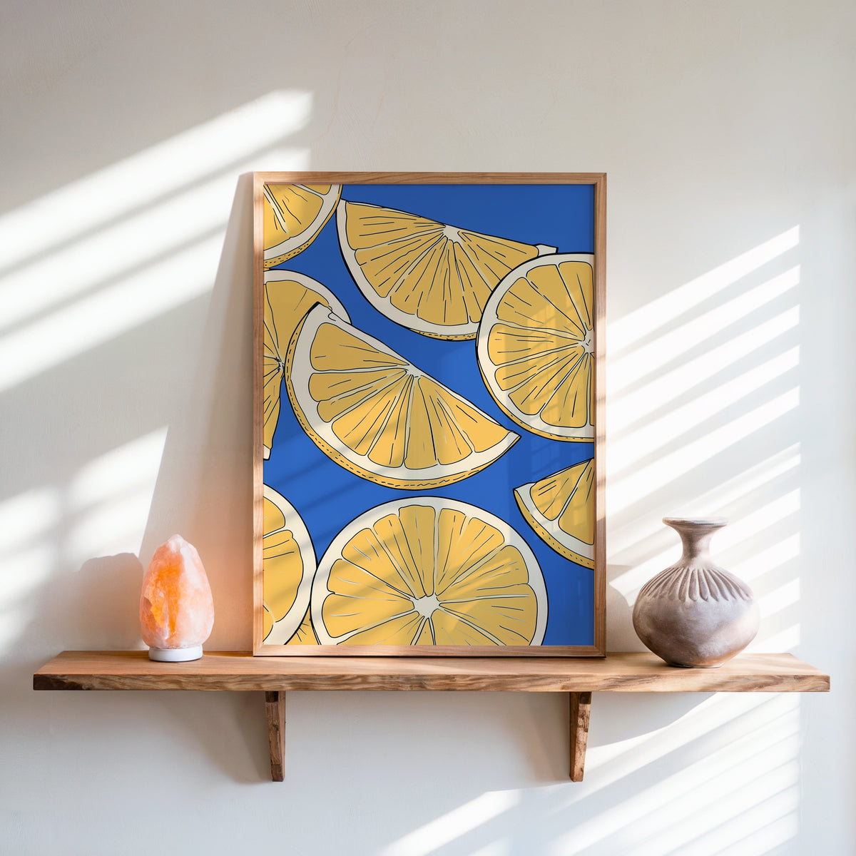 Lemon slice pattern print in an oak frame on a live-edge shelf beside a salt lamp