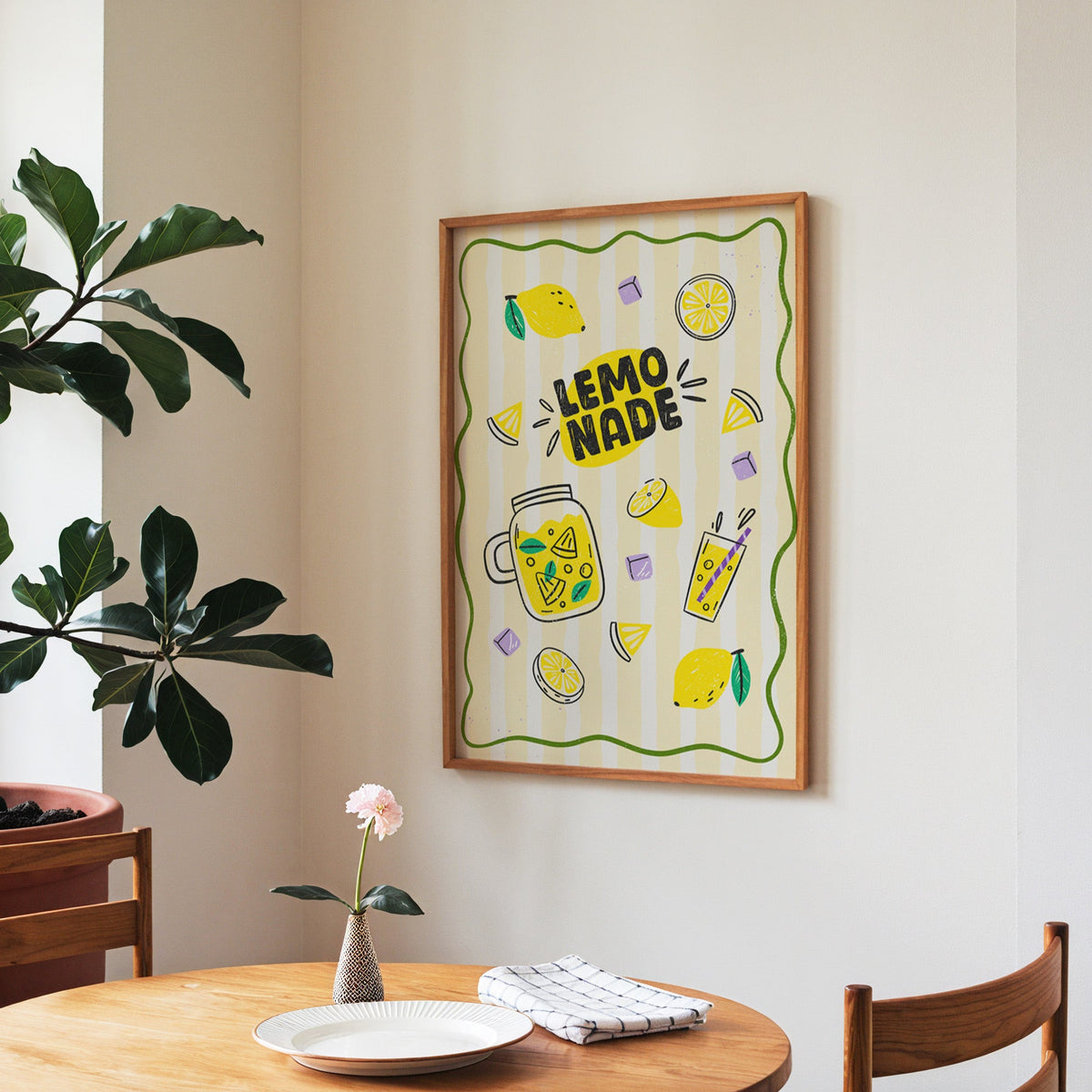 Lemonade Stand print in a walnut frame above a round table beside a fiddle-leaf fig