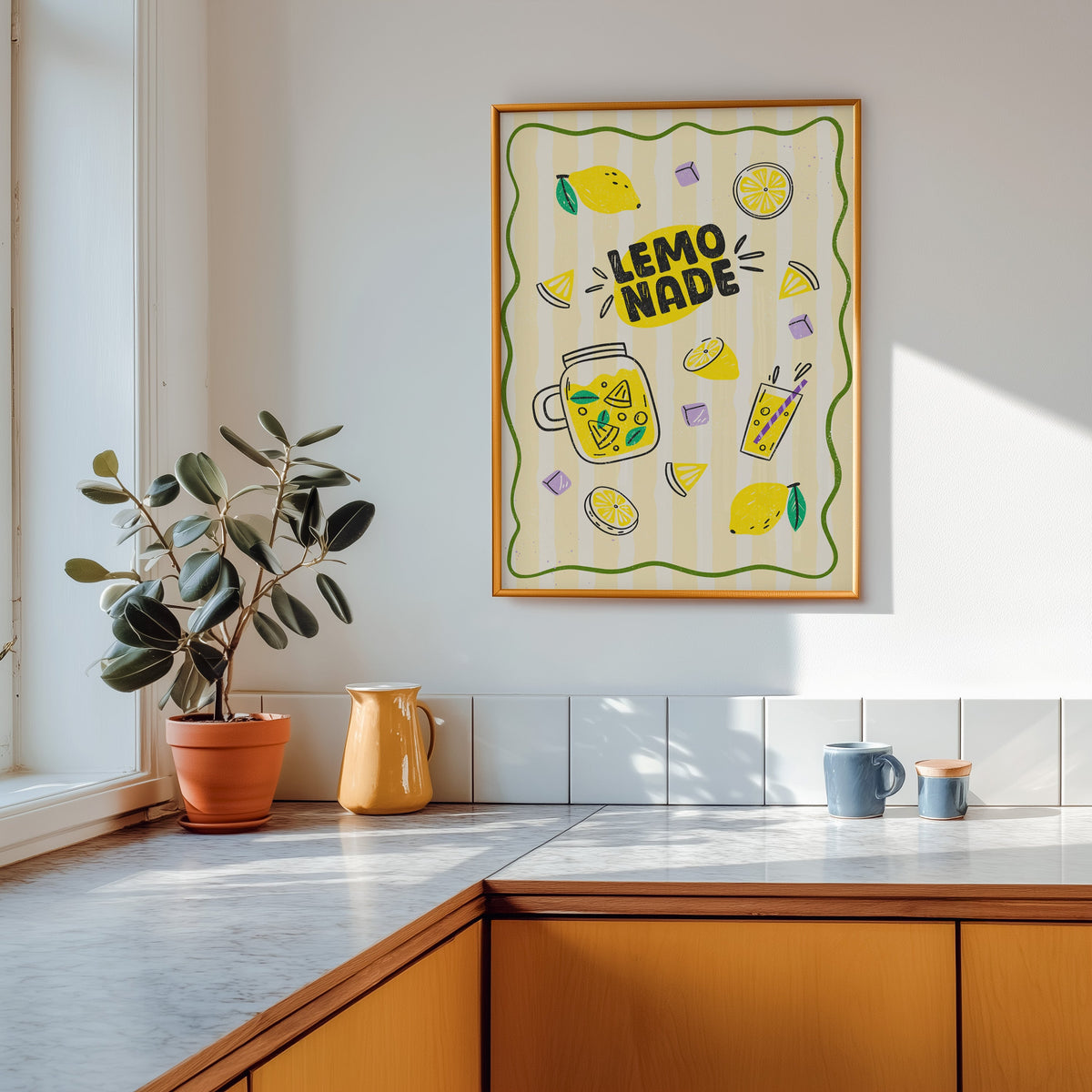Lemonade Stand print shown in a gold frame above a marble counter in a tan kitchen